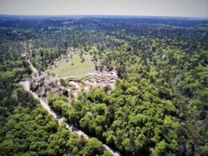 Aerial view of wooded land and a clearing near Spanish Fort in Baldwin County, Alabama